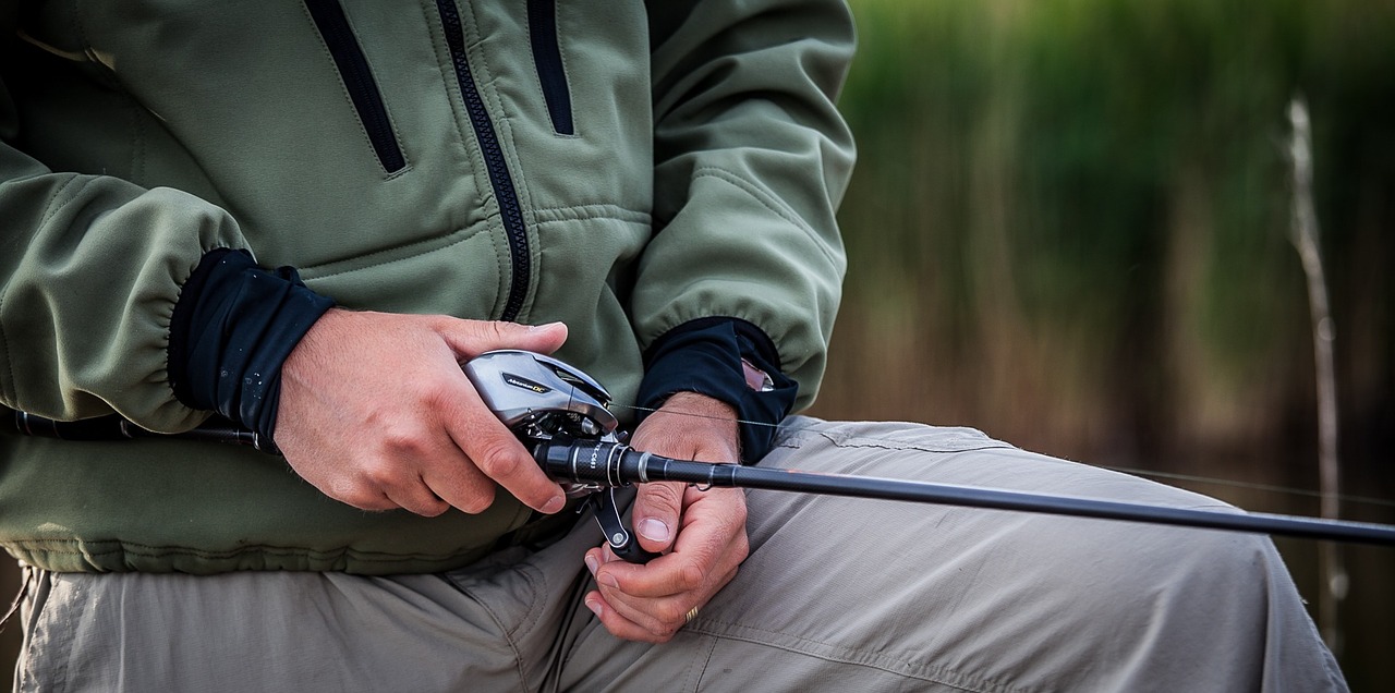 Fisherman with bait caster rod and reel.
Image from Pixabay